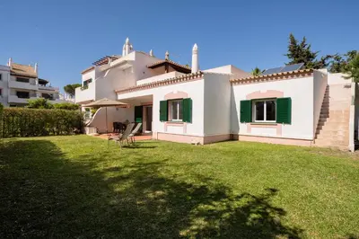 a swimming pool with a gazebo and a house at SOLAR DO GOLFE - Vilamoura in Vilamoura