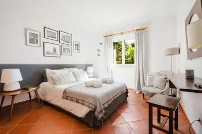 a bedroom with two beds and a lamp on a table at SOLAR DO GOLFE - Vilamoura in Vilamoura