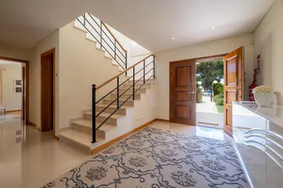 a hallway with a staircase and a door with a rug at VILLA SIBLING 2 in Vilamoura