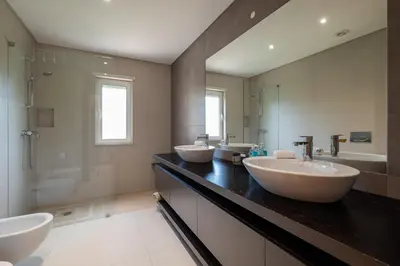 a bathroom with three sinks and a shower at VILLA SIBLING 2 in Vilamoura