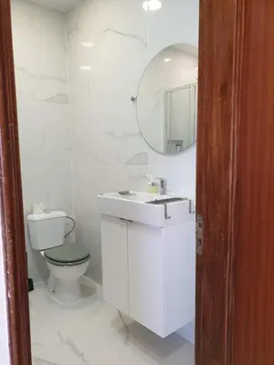 a bathroom with a toilet and a sink and a mirror at AAA Apartments in Albufeira
