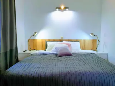 a bed with a purple pillow on top of it at AAA Apartments in Albufeira