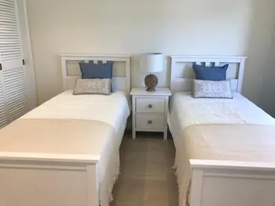 two beds sitting next to each other in a bedroom at São Rafael Beach Apartment in Albufeira