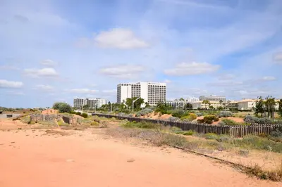 a view of a city with buildings and a dirt road at Irene's Place Marina in Quarteira