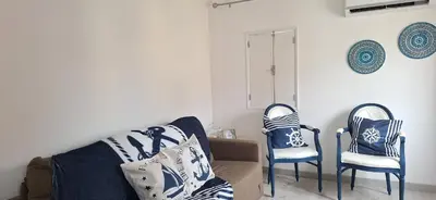 a living room with two chairs and a couch at Irene's Place Marina in Quarteira
