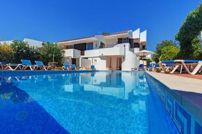 a large swimming pool in front of a house at CASA MALINDI in Albufeira