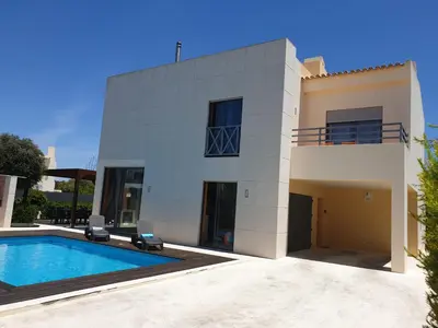 a house with a swimming pool in front of it at Albufeira Oura Beach V4 Villa Marisa with private Pool in Albufeira