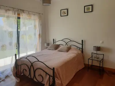 a bedroom with a bed and a large window at Albufeira Oura Beach V4 Villa Marisa with private Pool in Albufeira