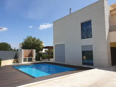 a swimming pool in front of a house at Albufeira Oura Beach V4 Villa Marisa with private Pool in Albufeira