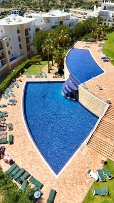 an overhead view of a large swimming pool with chairs at AlbufeiraOrada Splendor by Be Cherish in Albufeira