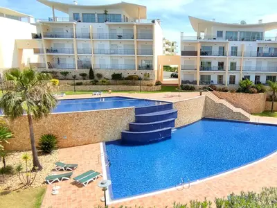 a swimming pool in front of a large apartment building at AlbufeiraOrada Splendor by Be Cherish in Albufeira