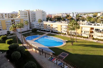 a living room with a couch and a tv at MouraPraia By Garvetur in Vilamoura
