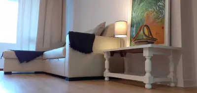 a living room with a couch and a table at Casa dos Teixeiras in Quarteira