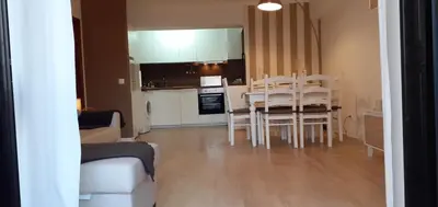 a kitchen and dining room with a table and chairs at Casa dos Teixeiras in Quarteira