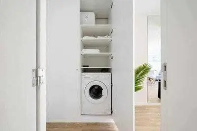 a washer and dryer in a white room at Vilamoura new style apt piscina wifi in Vilamoura