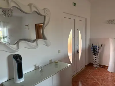 a white bathroom with a mirror on the wall at Quinta das Nespereiras in Patã de Cima