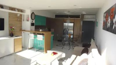 a kitchen and a living room with a couch and a table at CASA OKSANA in Albufeira