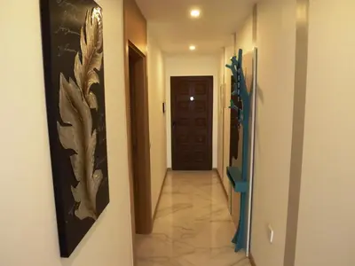 a hallway with a door and a tile floor with a hallwayngth at CASA OKSANA in Albufeira