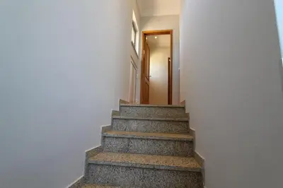 a stairway leading up to a door in a building at Villa Martina - São Rafael - Albufeira in Albufeira