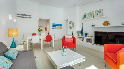 a living room with red chairs and a table at Victory Village, Quinta do lago in Almancil