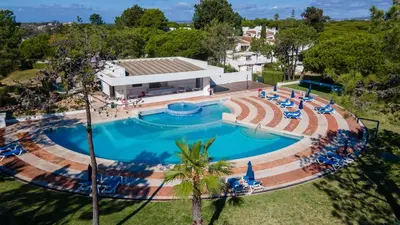a view of a pier over the water with trees at Victory Village, Quinta do lago in Almancil