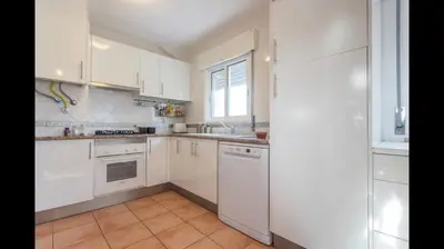 a white kitchen with white appliances and a window at Apartment in Vilamoura (Marina) in Vilamoura