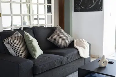 a living room with a gray couch with pillows at Marina Club - Sea front - Vilamoura in Vilamoura
