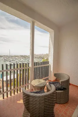 a balcony with two chairs and a table on a balcony at Duplex Marina de Vilamoura in Vilamoura
