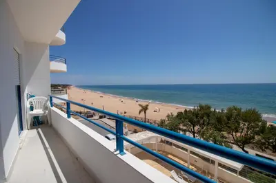 a balcony with a view of the beach at Quarteira Beach in Quarteira