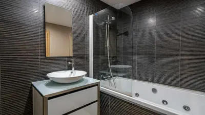 a bathroom with a sink and a mirror and a tub at Marina Vilamoura Aquamar 220 By Vilamoura Sun in Quarteira