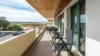 a balcony with chairs and a view of a street at Marina Vilamoura Aquamar 220 By Vilamoura Sun in Quarteira