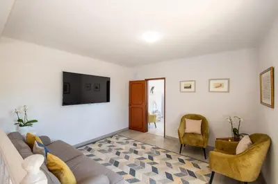 a living room with a couch and a tv at Casa Katarina - Private Villa - Heated pool - Free Wifi - Air Con in Tunes