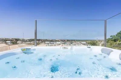 a jacuzzi tub with a view of the ocean at D_Loft Ocean in Albufeira