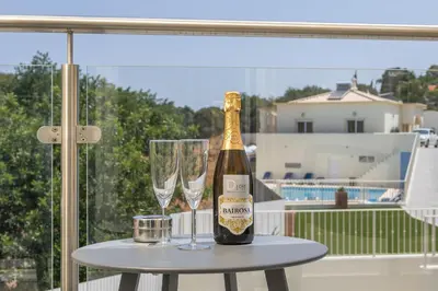 a bottle of champagne and two glasses on a table at D_Loft Ocean in Albufeira