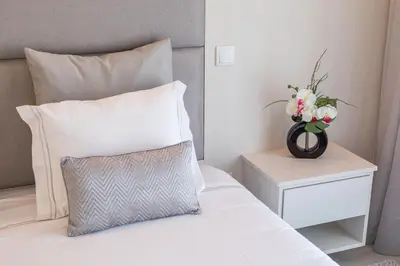 a bedroom with a bed with a vase of flowers on it at D_Loft Ocean in Albufeira