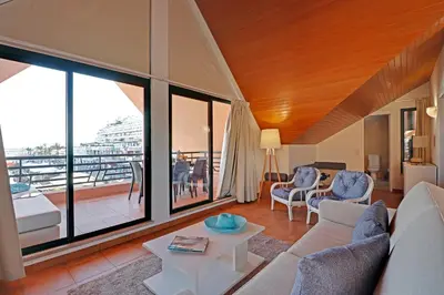 a living room with a couch and a table at Marina Princess in Vilamoura