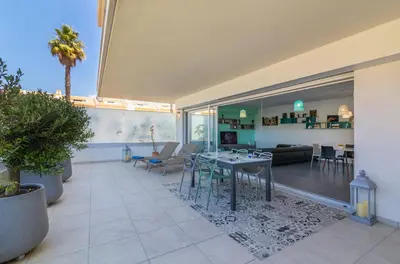 a living room with a table and a couch at Garden Design in Albufeira