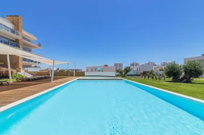 a large swimming pool in the middle of a building at Garden Design in Albufeira