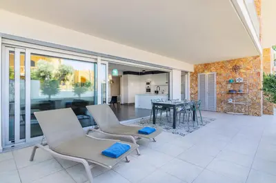 a living room with two chairs and a table at Garden Design in Albufeira