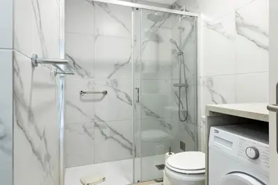 a bathroom with a glass shower with a toilet at Moura Suites III - Relaxing view - Vilamoura HD Properties in Vilamoura