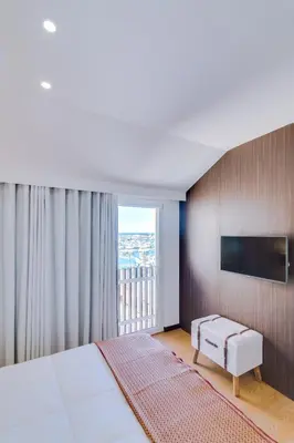 a bedroom with a large bed and a large window at Gold II - Luxurious apartment - Vilamoura in Vilamoura