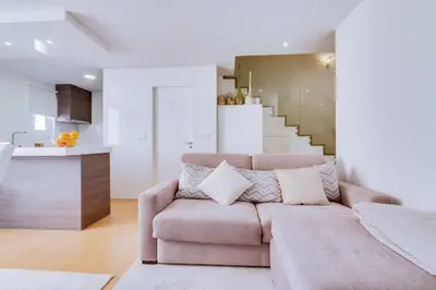 a living room with a couch and a staircase at Gold II - Luxurious apartment - Vilamoura in Vilamoura