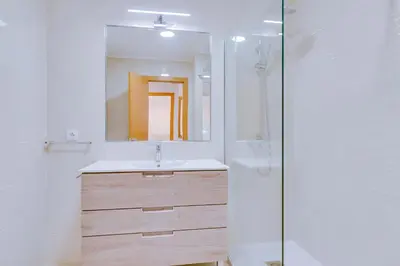 a bathroom with a sink and a mirror at Tália I - City Center - Vilamoura in Vilamoura