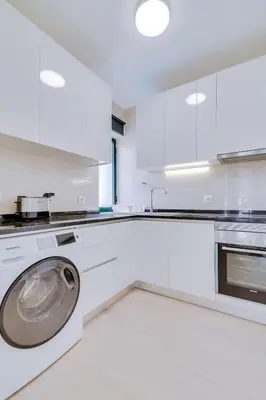 a white kitchen with a washing machine in it at Tália I - City Center - Vilamoura in Vilamoura