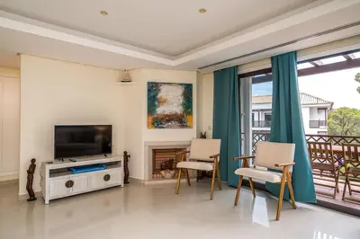 a living room with a tv and a fireplace at CAROB APARTMENT - BY MAYORAL (FALÉSIA BEACH) in Olhos de Água