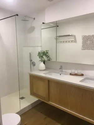 a bathroom with a sink and a glass shower at Porta 20 in Loulé