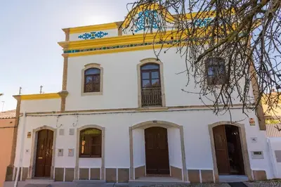 a large white building with a yellow roof at Solar da Rosa & Solar da Tirosa in Boliqueime
