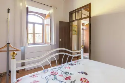 a bedroom with a bed and a window at Solar da Rosa & Solar da Tirosa in Boliqueime