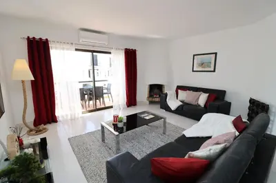a living room with a couch and a table at Apt T2 Praia São Rafael Hibiscus 18A - Albufeira, Algarve in Albufeira