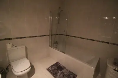a bathroom with a shower and a toilet and a tub at Apt T2 Praia São Rafael Hibiscus 18A - Albufeira, Algarve in Albufeira